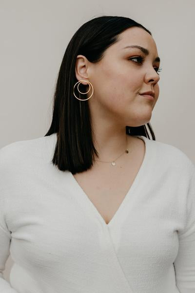 By TUMBLE. Double Hoop Gold Filled Earrings. 14k gold filled lightweight. All earring posts are sterling silver and comes with clear earring backs. Measures approximately 1.5 inches.