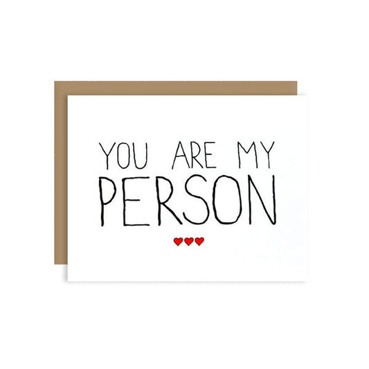 By Unblushing by Julie Ann Art. Person Card: 100% recycled kraft envelope. Professionally printed on 110# recycled card stock. Packaged in a compostable clear sleeve. Blank inside for your own personal message. Measures 5.5 x 4.25 (A2) folded card. Also available in store at FOLD Gallery DTLA.