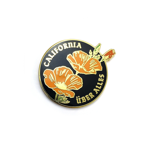 By World Famous Original. Gold finish hard enamel California Uber Alles Pin. Show your California Love with a Dead Kennedys reference thrown in for good measure! Measures 1.2 inches. Also available in store at FOLD Gallery in DTLA.