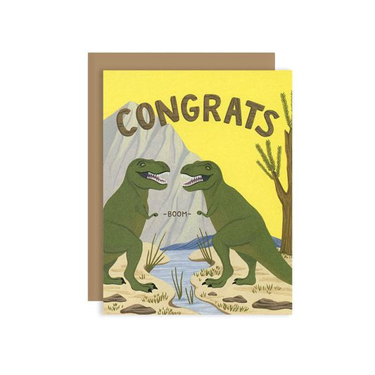 By Yeppie Paper. T-Rex Fist Bump Congrats Card. Professionally printed in full color in Los Angeles. FSC-certified, recycled 110 lb. cover weight, soft white paper. Matching recycled kraft envelope. Blank inside with single color logo on back. Card and envelope packaged in a clear cello sleeve. Measures 4.25 x 5.5. Also available in store at FOLD Gallery DTLA.