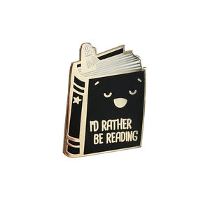By Ilootpaperie. Soft enamel I'd Rather Be Reading Pin with gold base. Ships as a single pin on card. Measures approximately 1.25 inch tall x 1 inch wide. Also available in store at FOLD Gallery DTLA.